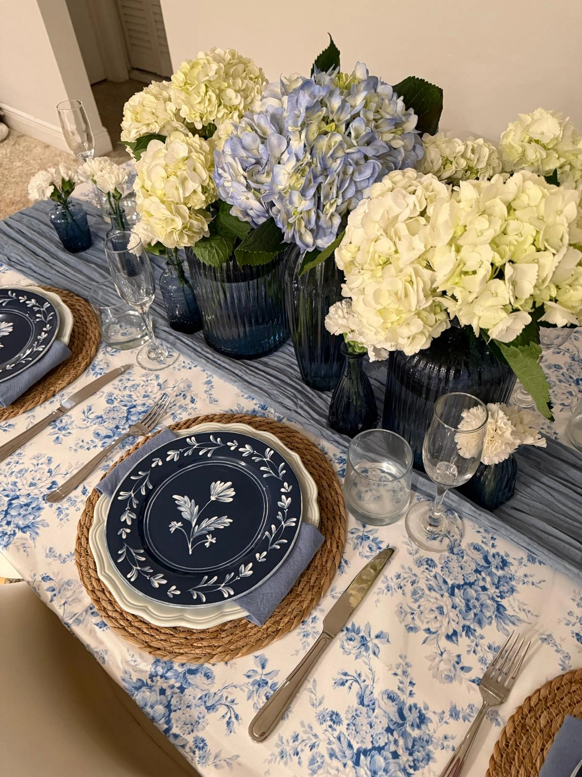 Elegant white and blue Maison Lucia table styling with refined floral details